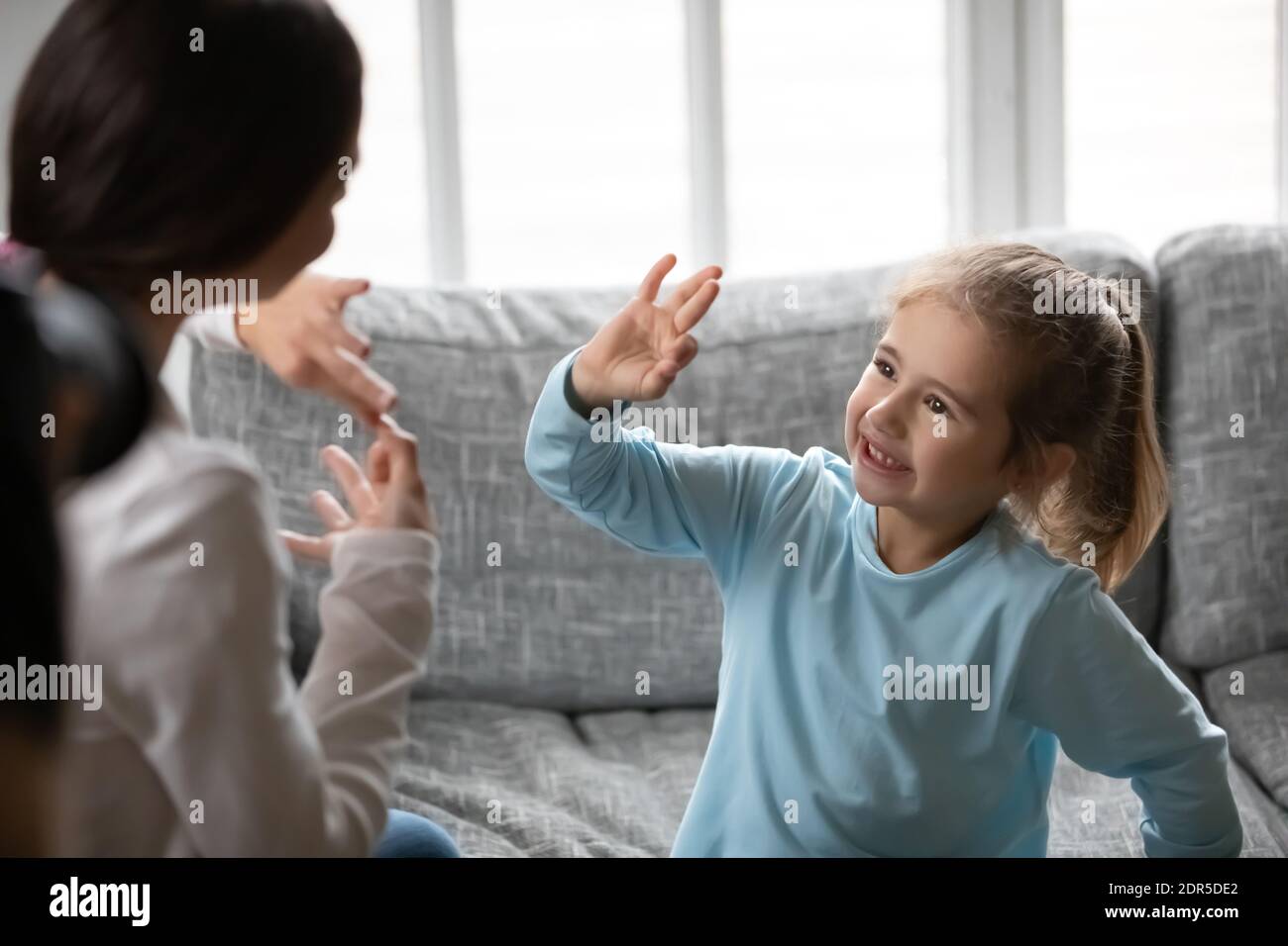 Close up deaf little girl communicating with mother Stock Photo