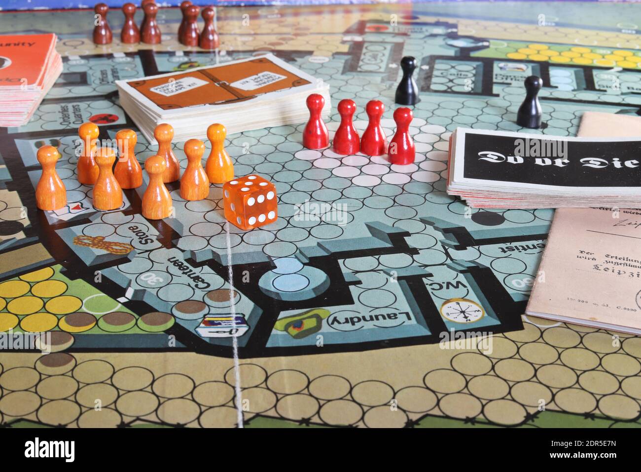 UK - Escape from Colditz board game from the 1970s. Orange, red and black playing pieces. Stock Photo