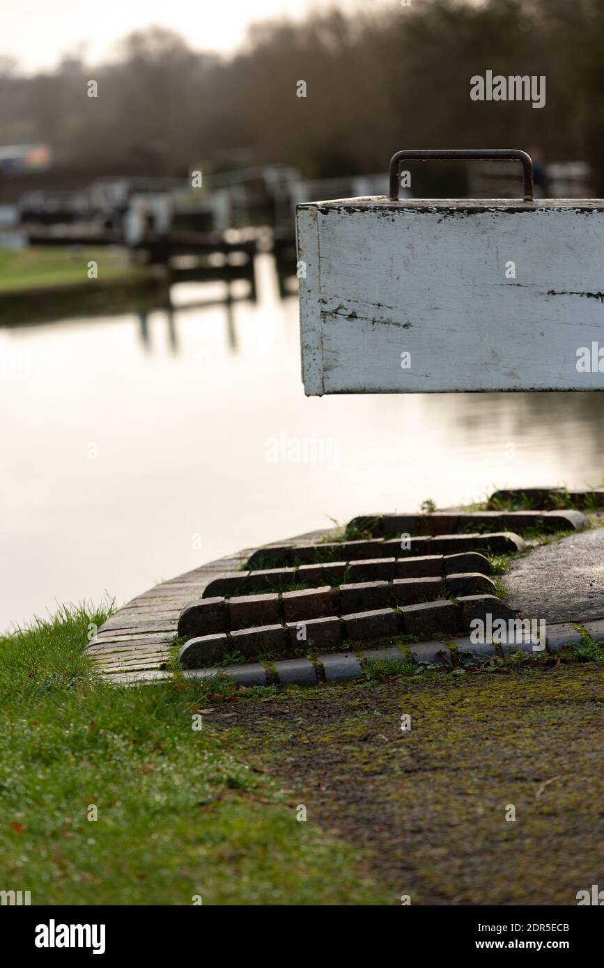 lock gate with steps for helping open them at canal lock Stock Photo
