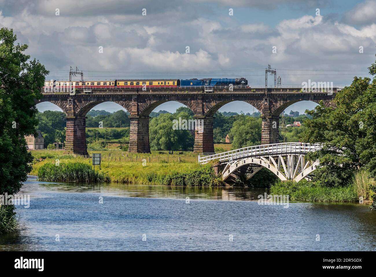 The Border Raiders railtour hauled by A4 Pacific steam locomtive Tornado crosses the Dutton viaduct across the River Weaver heading north. The old cow Stock Photo