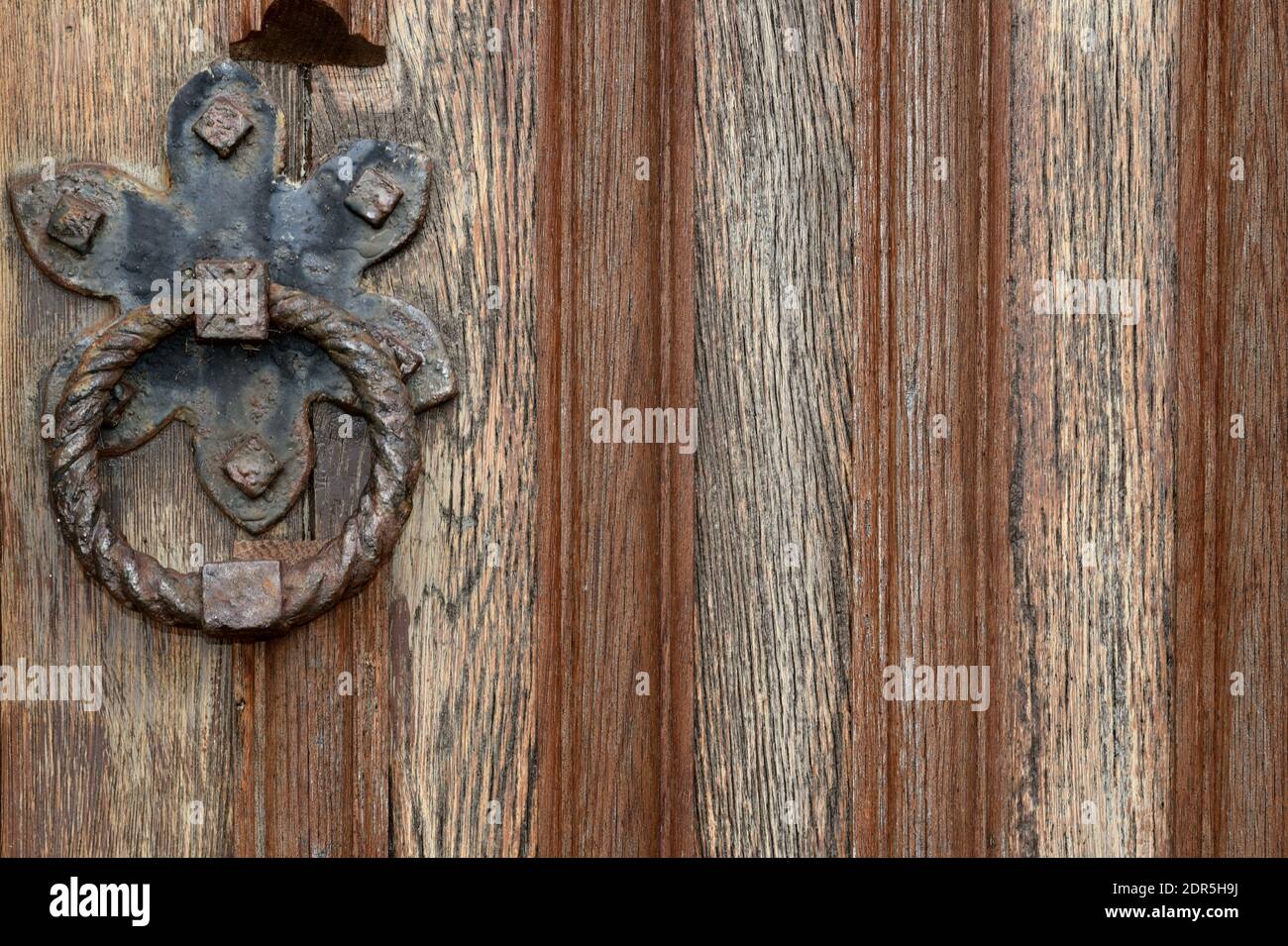 Close-up of old wooden door background with iron ring Stock Photo