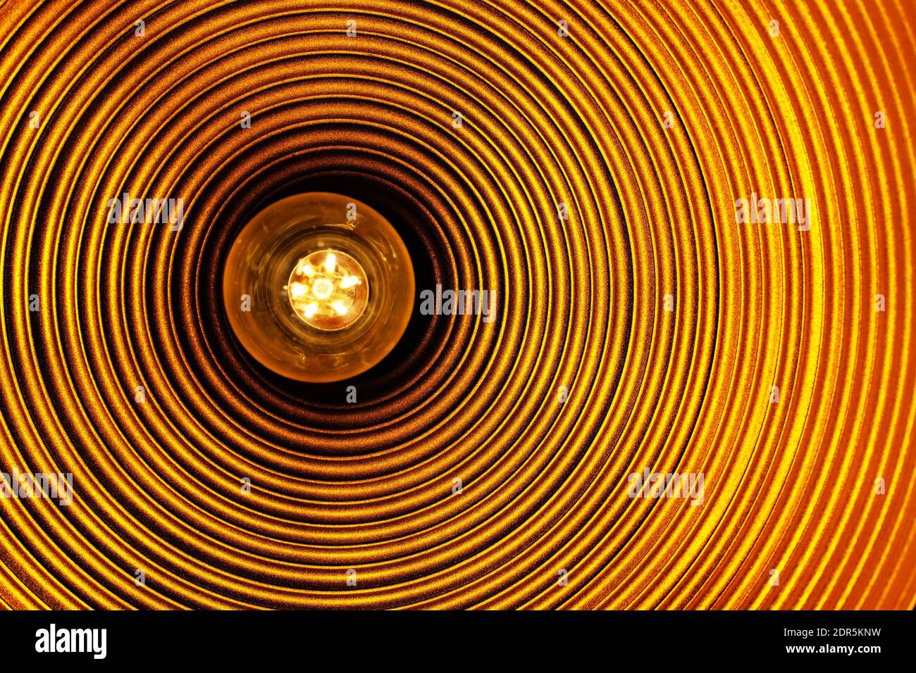 lightbulb in an orange lamp - concept photo Stock Photo