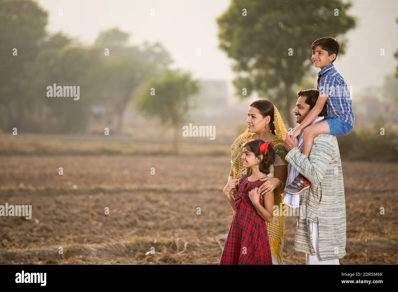 Happy rural Indian family on agricultural field Stock Photo - Alamy