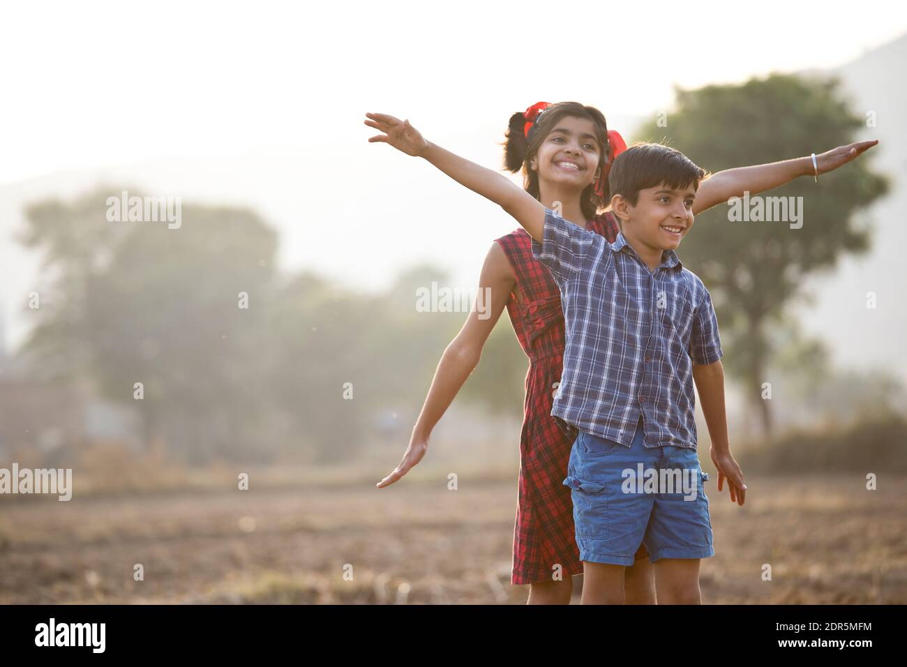 Happy children having fun in agricultural field Stock Photo - Alamy