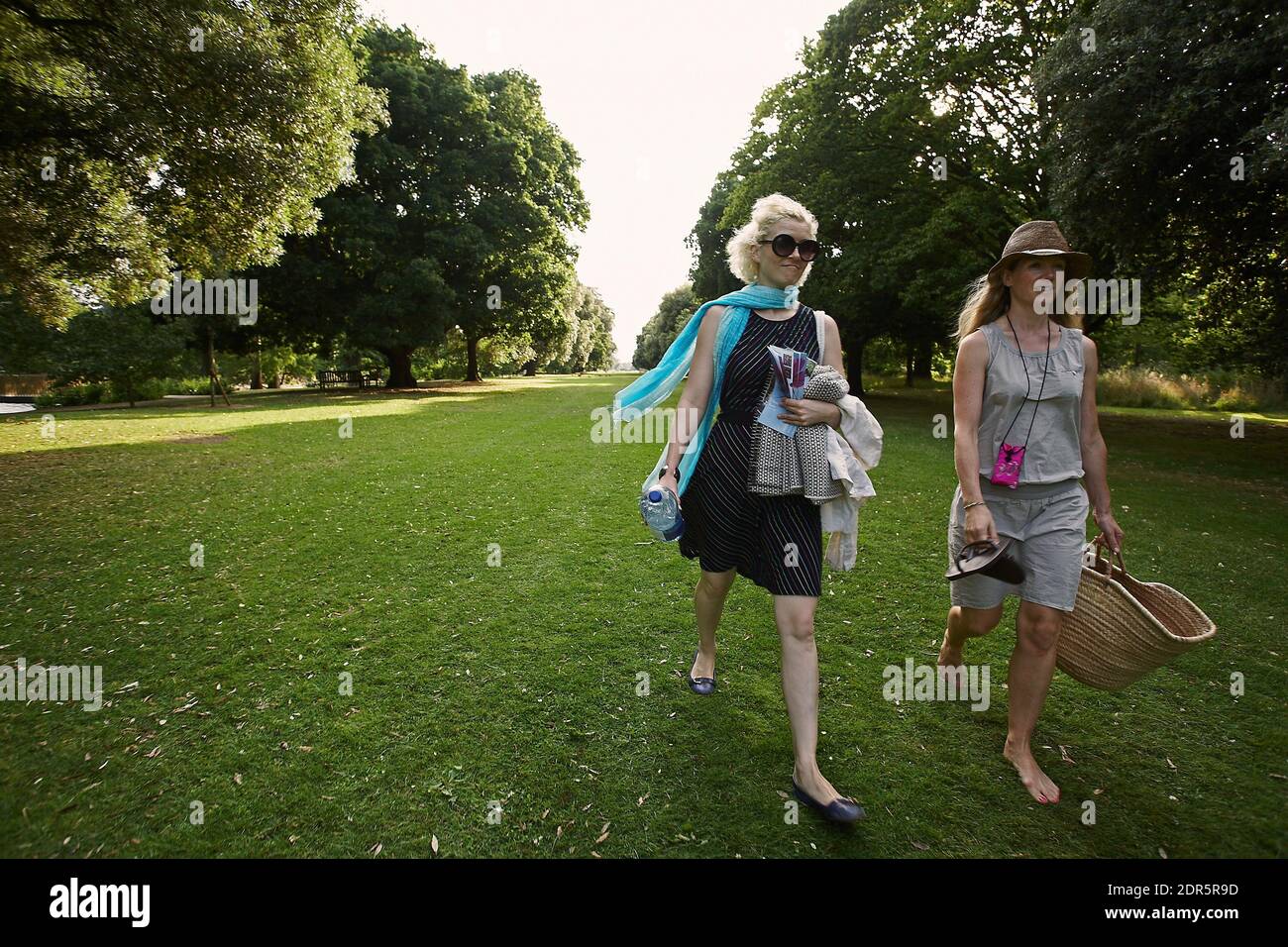 Two young woman walking at at Royal Botanic Gardens, Kew, London, England Stock Photo