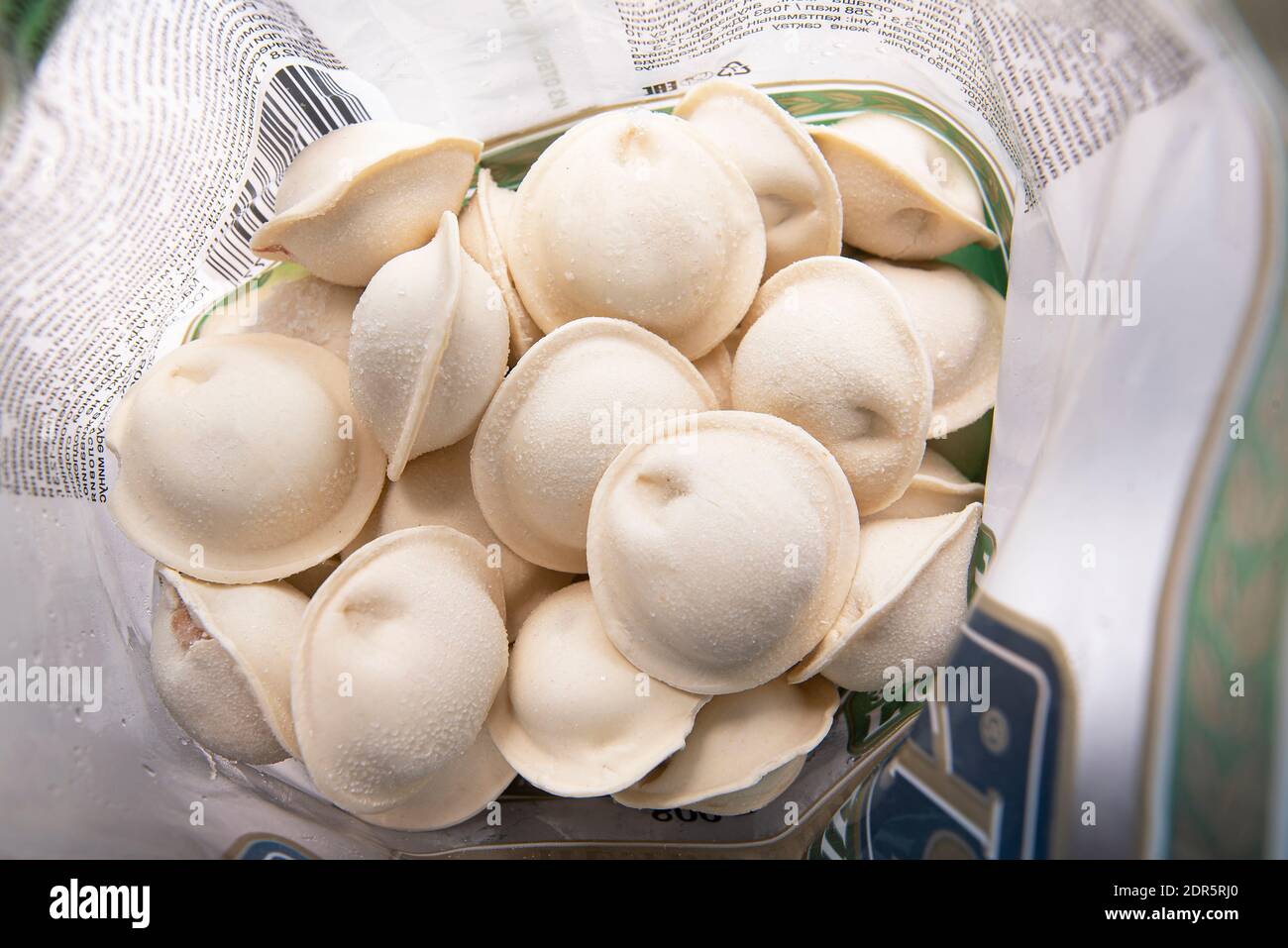 MOSCOW - DEC 20: Opened pack with frozen Russian dumplings or pel'meni on table in Moscow, December 20, 2020 in Russia Stock Photo