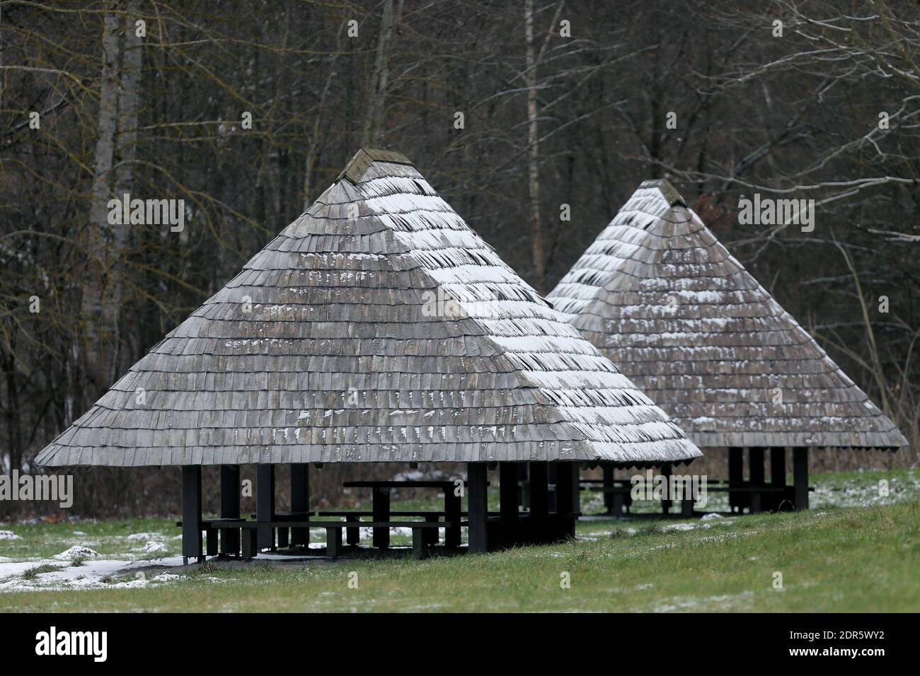 Leisure gazebo in the woods and garden with a snow-covered roof. Winter ...