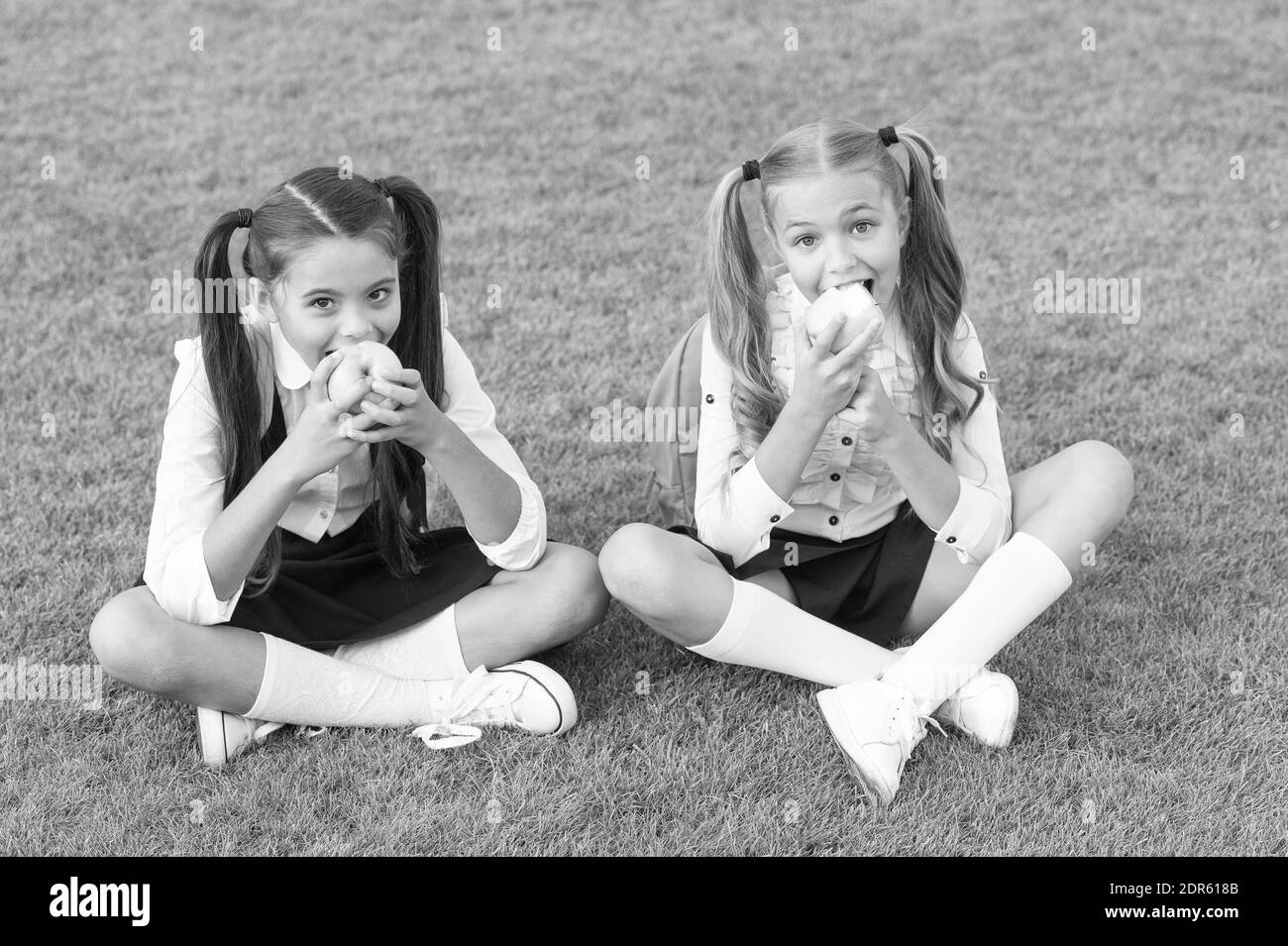 Girls small kids eating green apples, healthy lunch concept. Stock Photo