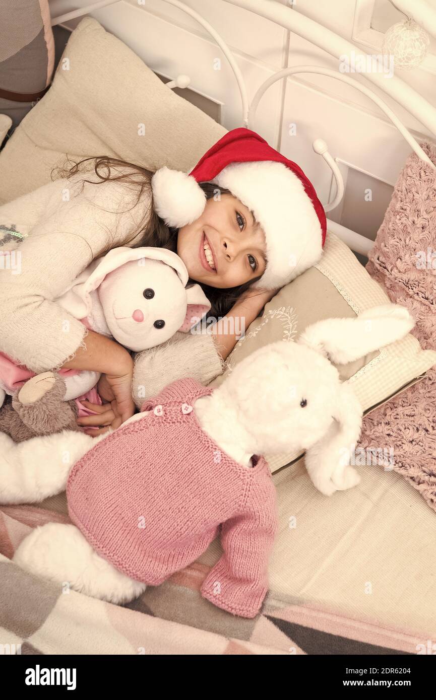 New year new smile. Santa baby go to sleep feeling happy. Little girl with happy smile relax in bed. Smile because you look pretty. Close each day with smile. Good night. Sweet dreams. Stock Photo