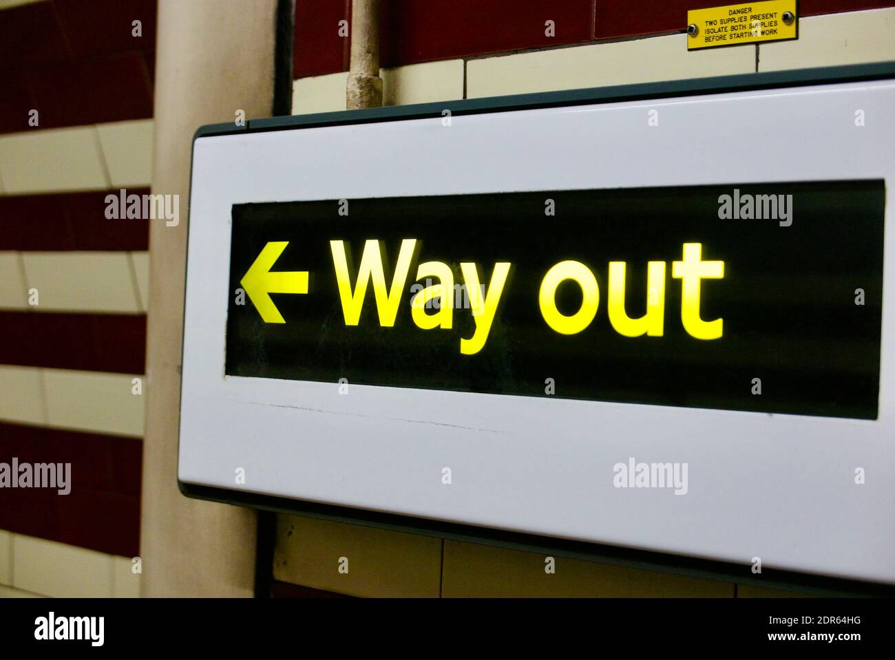 Way Out illuminated exit sign. Interior of Hampstead tube station on London Underground. Stock Photo