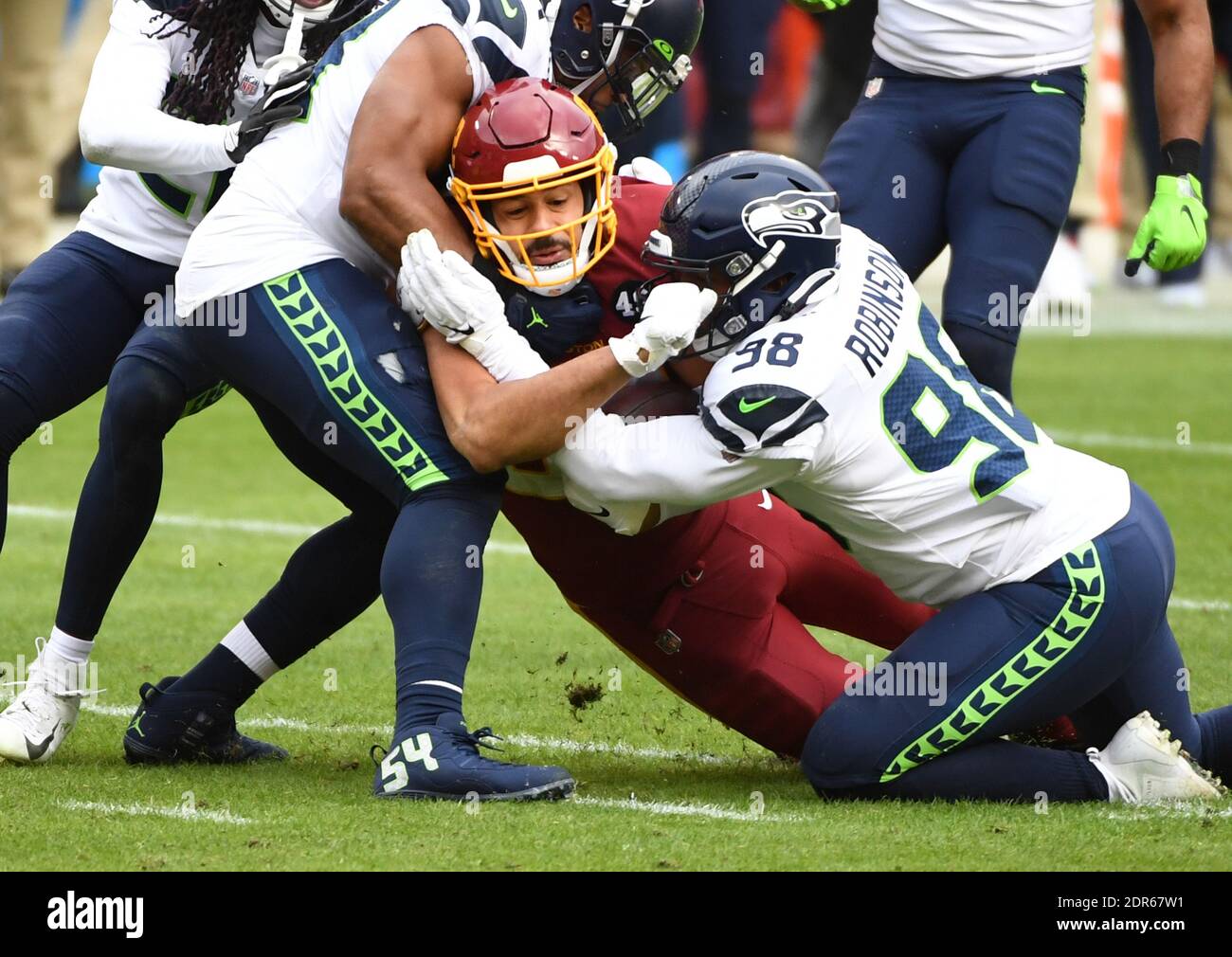 Landover, United States. 20th Dec, 2020. Washington Football Team tight end Logan Thomas (82) is tackled by Seattle Seahawks defensive end Alton Robinson (98) in the second quarter at FedEx Field in Landover, Maryland on Sunday, December 20, 2020. Photo by Kevin Dietsch/UPI Credit: UPI/Alamy Live News Stock Photo