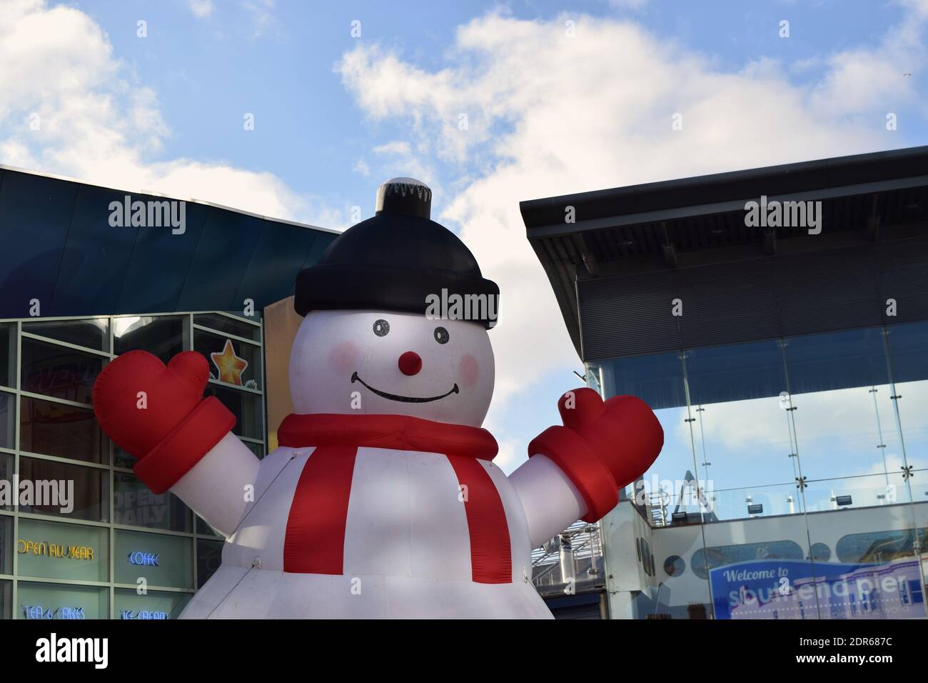 Giant Snowman with a smiling face in town centre on a nice sunny day. Stock Photo