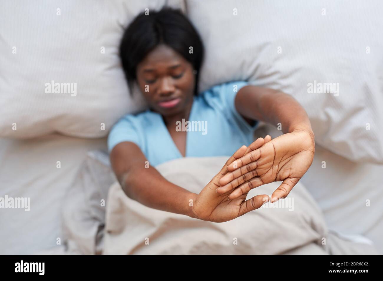 Minimal top view portrait of young AfricanAmerican woman stretching