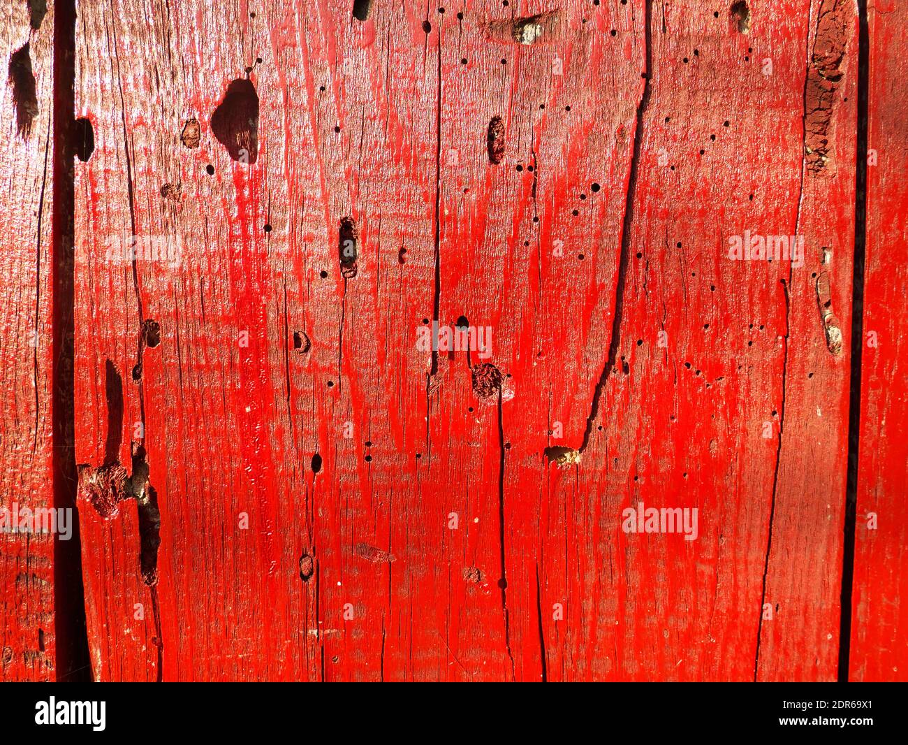 Texture of used wood planks painted red Stock Photo