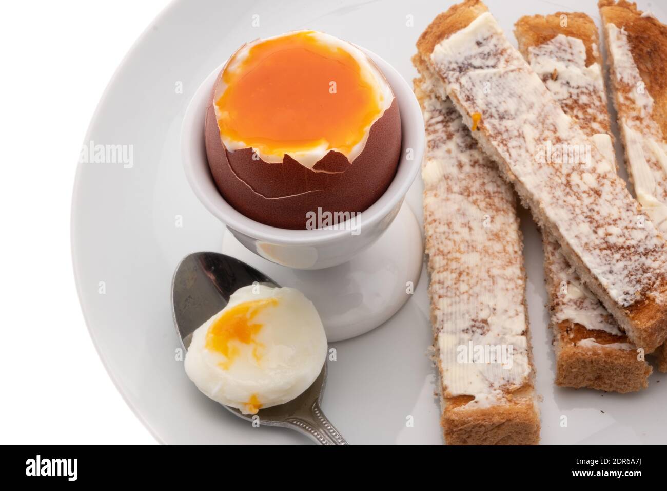 Soft boiled egg with toasted and buttered bread slices - white background Stock Photo