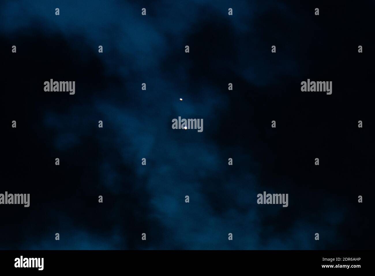 The great conjunction, becoming hidden by clouds Stock Photo