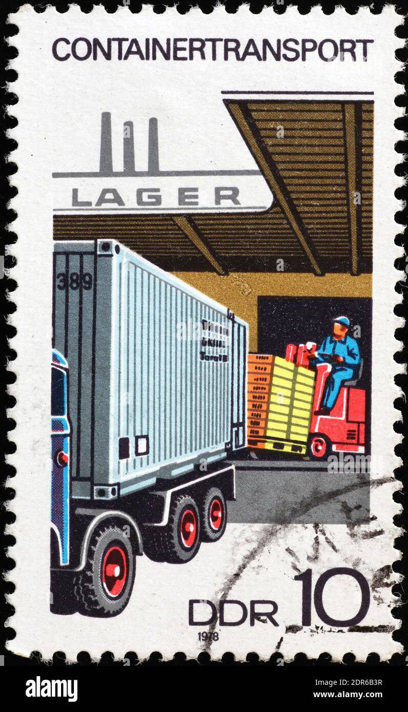 Loading a truck with a forklift on old stamp Stock Photo