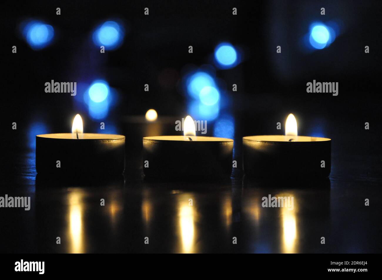 Christmas candles burning at night. Golden light of candle flame