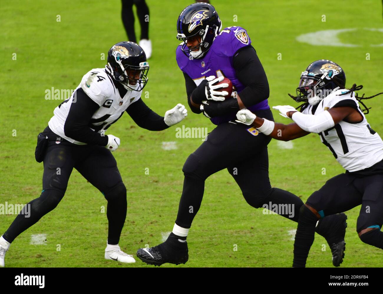 Baltimore, United States. 20th Dec, 2020. Baltimore Ravens guard Tyre  Phillips (C) runs into Jacksonville Jaguars defenders Myles Jack (44) and  Tre Herndon (37) after recovering a Baltimore fumble for a first