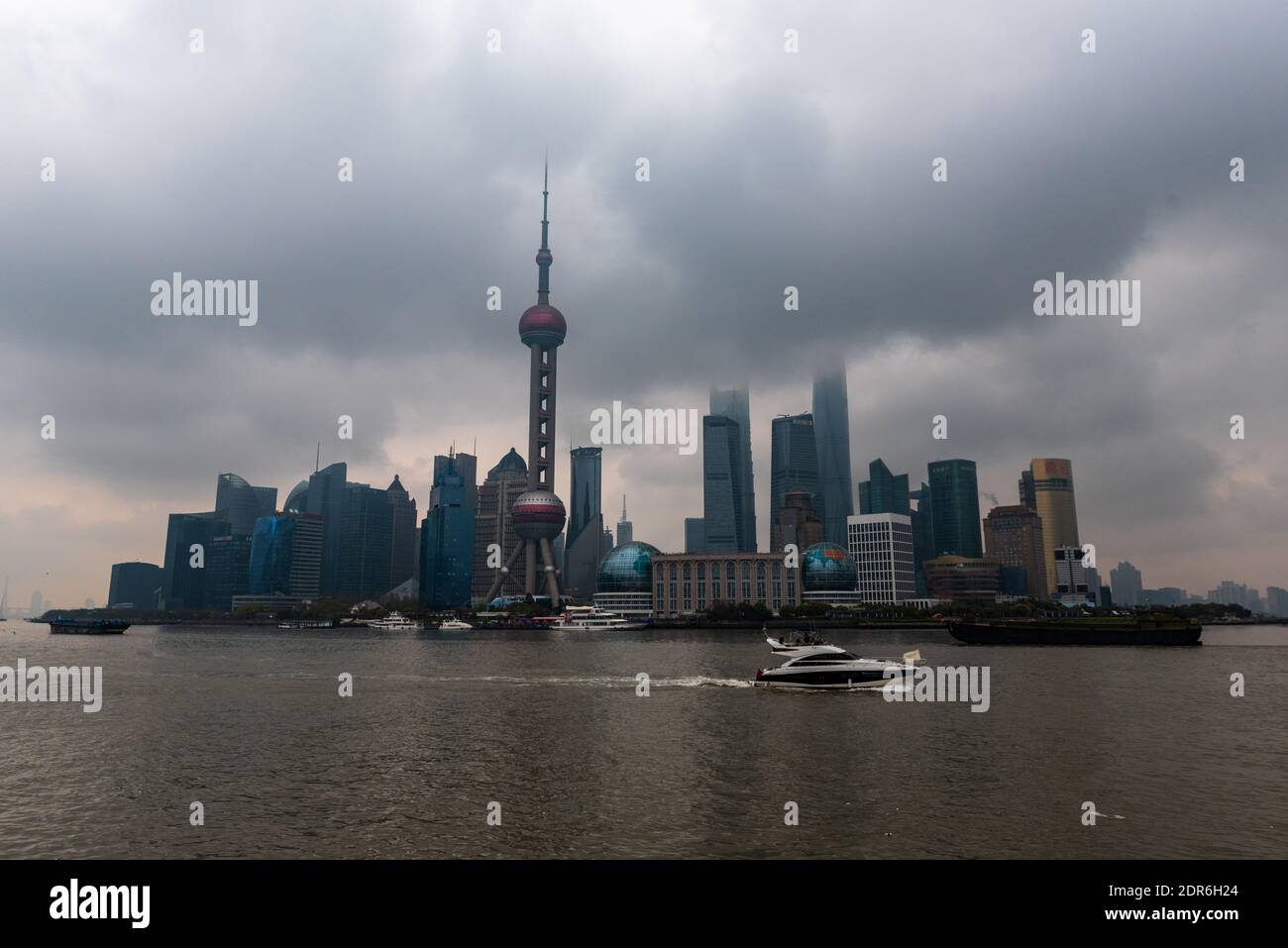 Shanghai, China -- March 30, 2016. A wide angle photo of the Shanghai skyline featuring the Oriental Pearl Tower on a foggy morning. Stock Photo