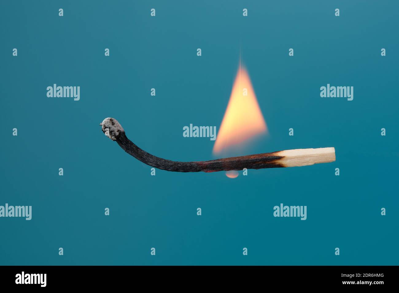 Burning Matchstick floating weightlessly Stock Photo