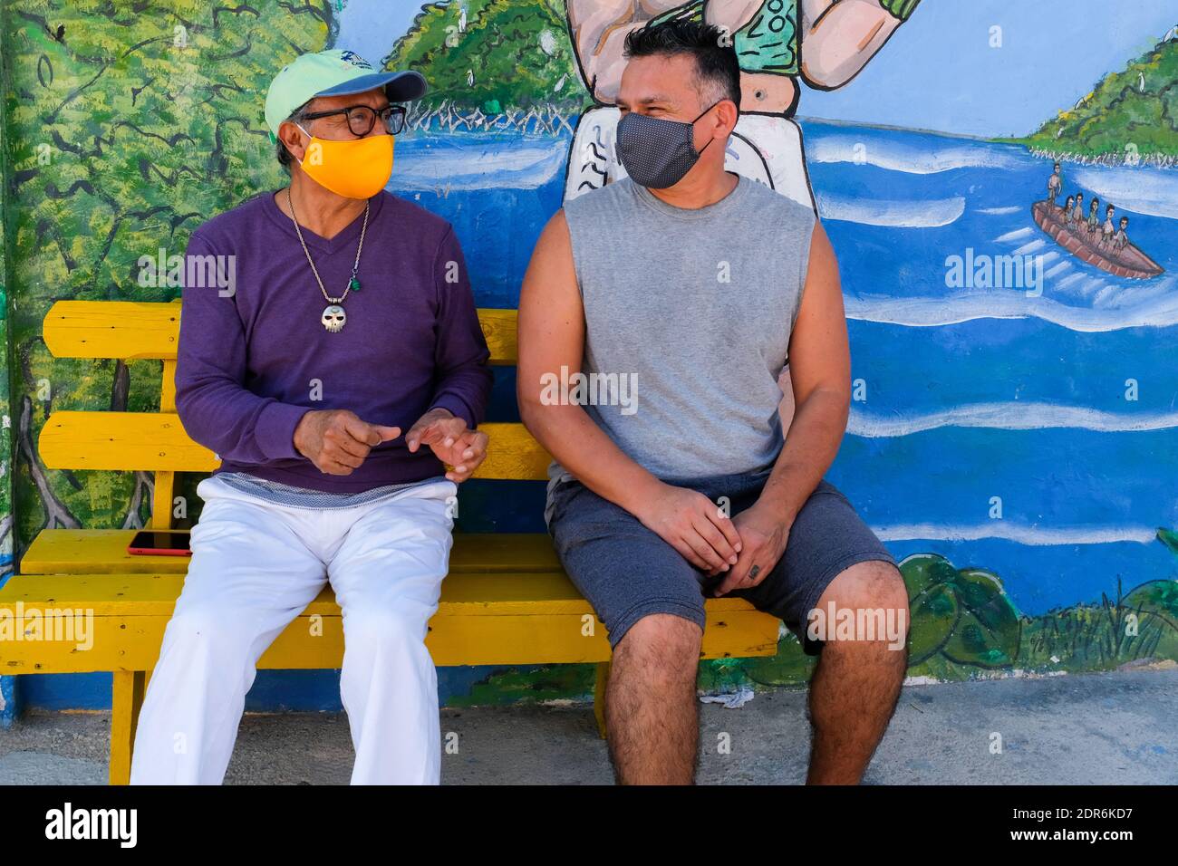 Men discussing during the Covid-19 pandemic in the small town of Sisal, Yucatan , Mexico Stock Photo