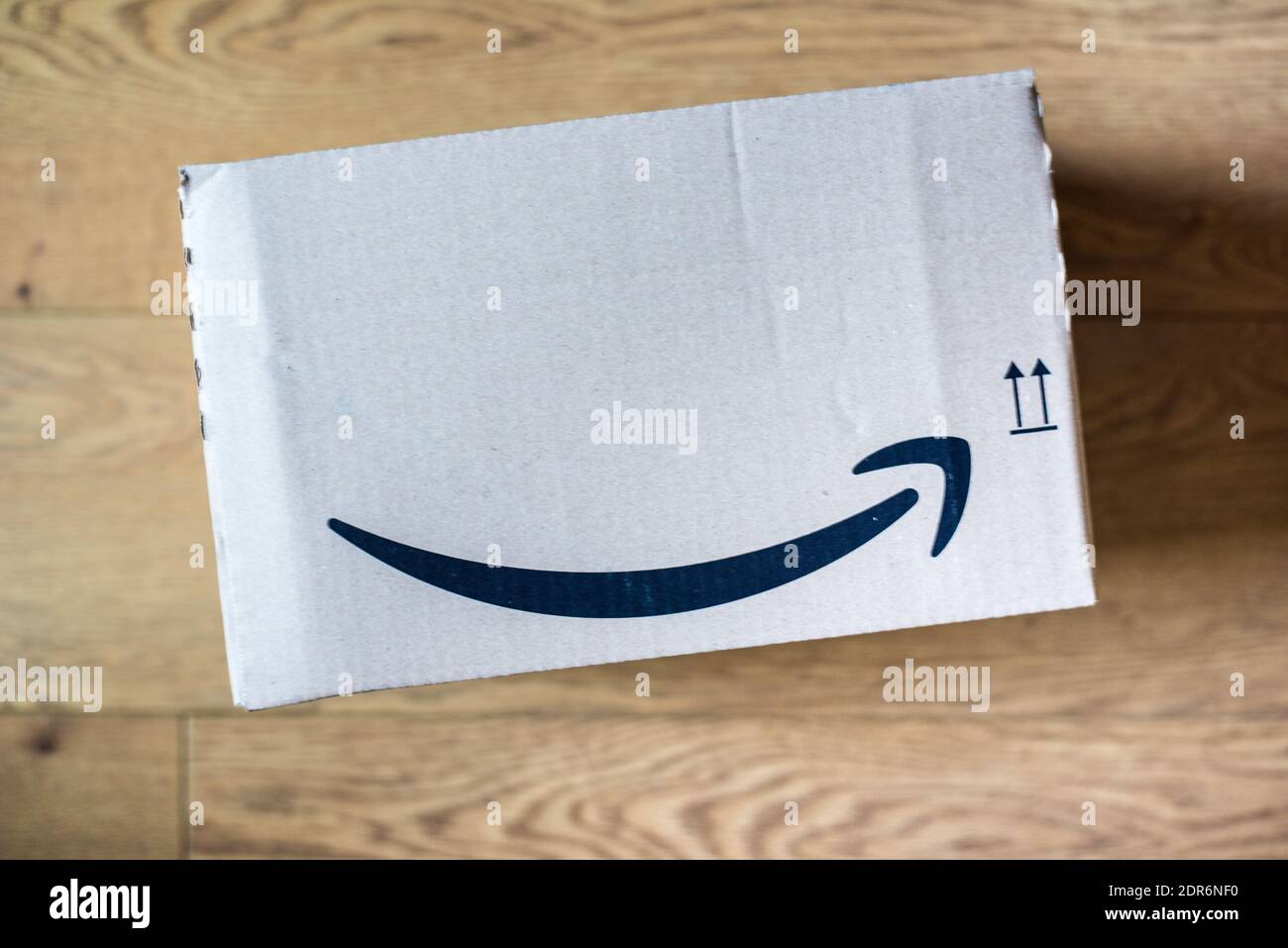 Amazon package box isolated on wooden floor background Stock Photo - Alamy