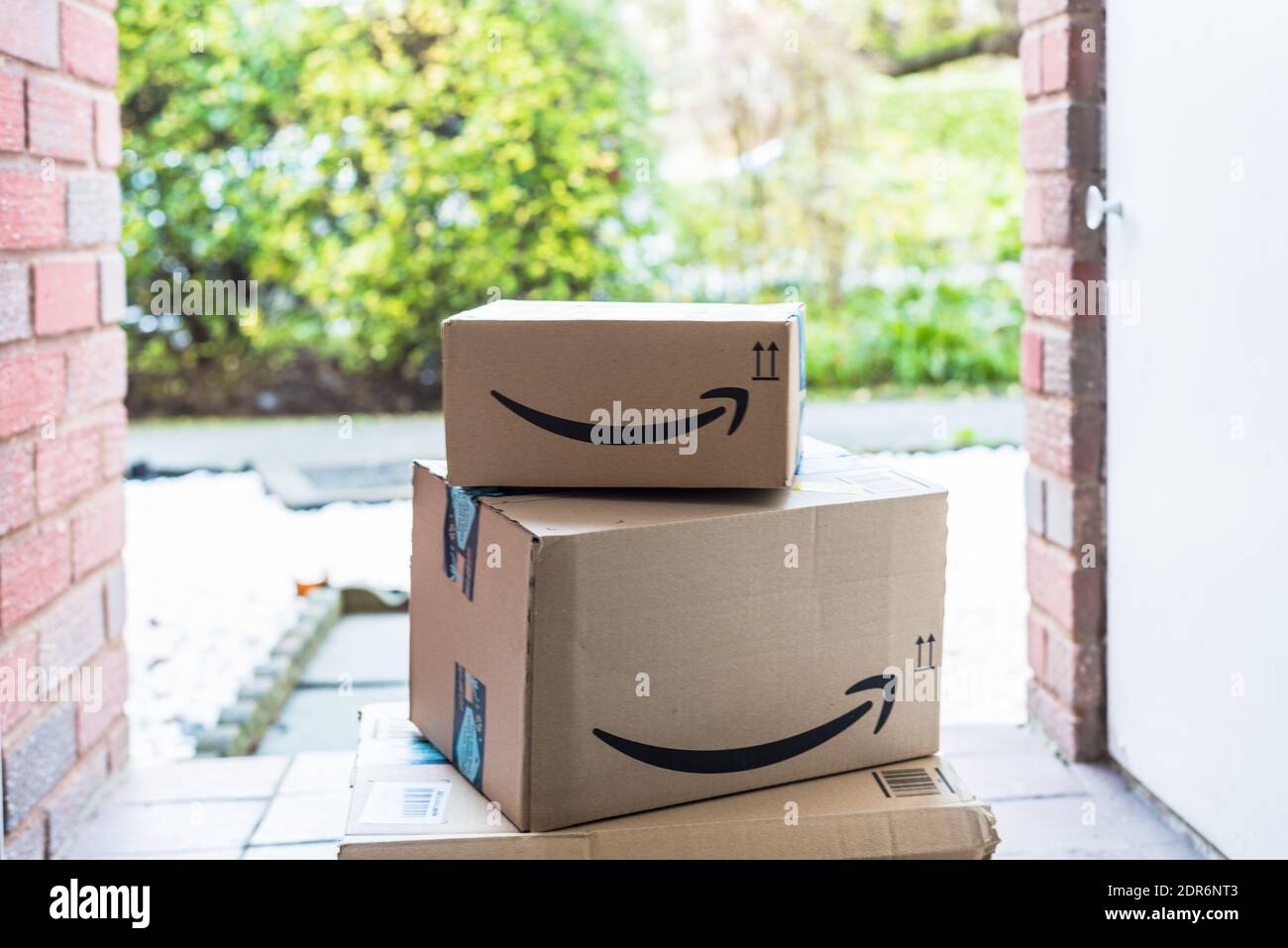 Amazon parcel stacked up cardboard box at door step Stock Photo