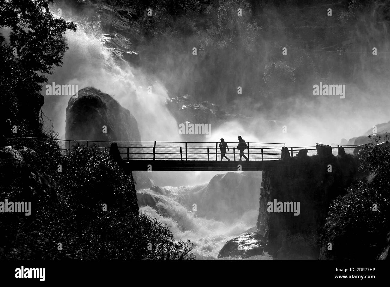 Silhouette People Walking On Bridge Against Waterfall Stock Photo - Alamy