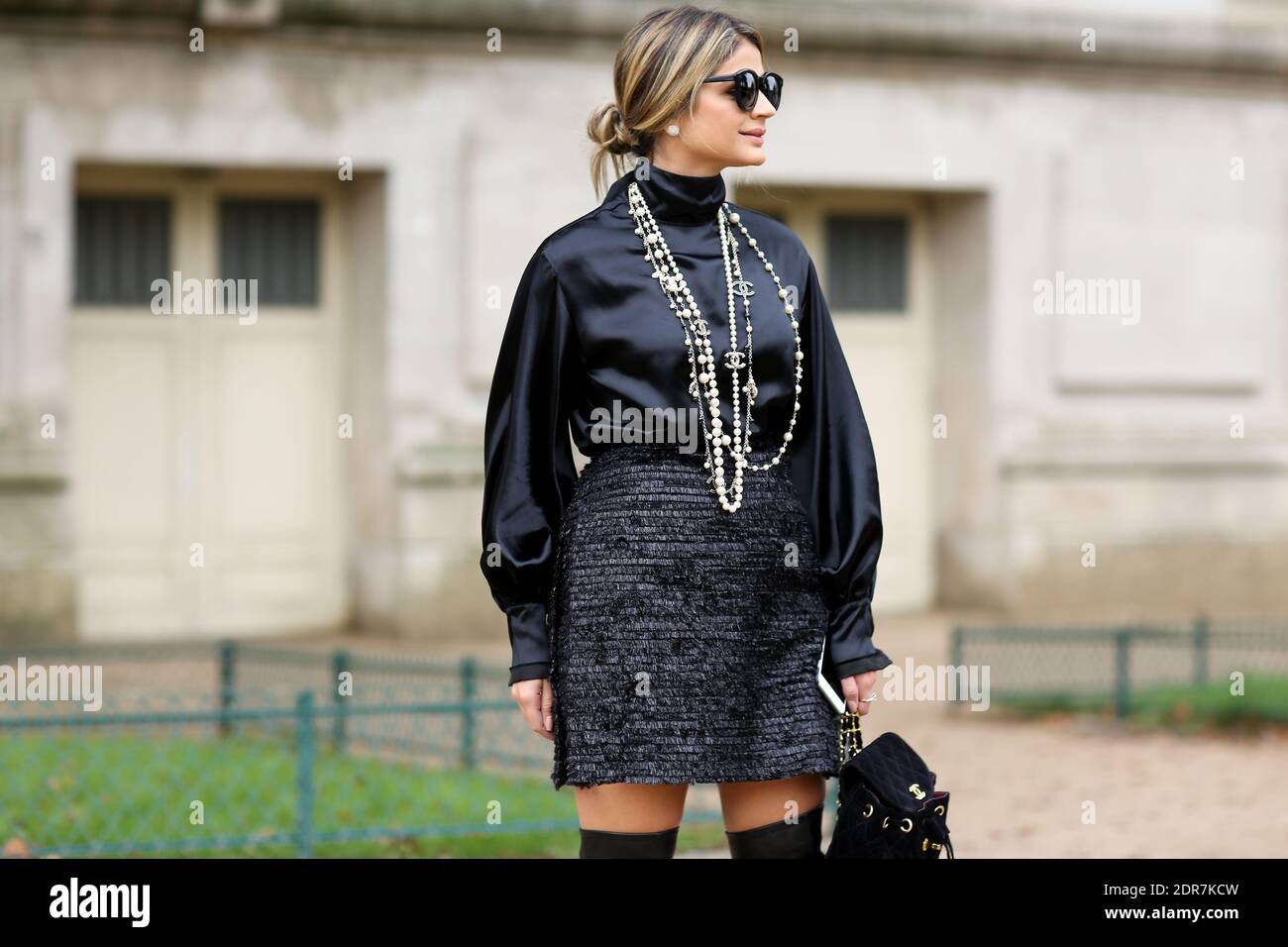 Fashion Blogger Thassia Naves wears a Chanel necklace, skirt and