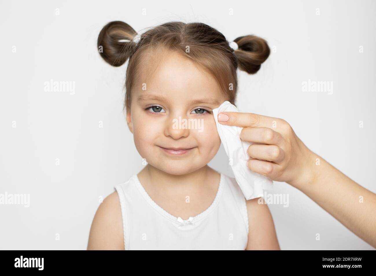 Hygiene, daily routine, skin care. Mommy's hand wiping the baby skin