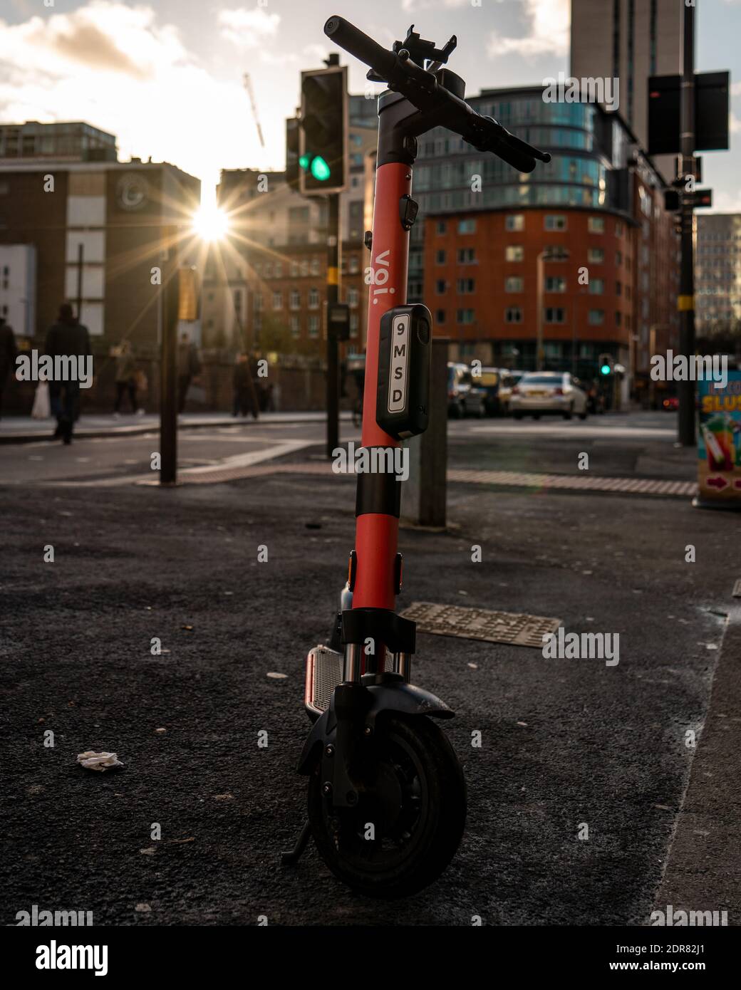 Birmingham, United Kingdom - December 12 2020: Voi. Electric Scooter on Birmingham street with setting sun Stock Photo