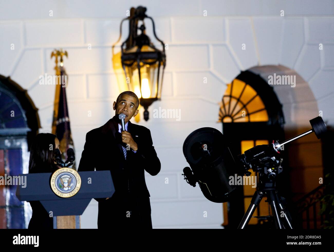 US President Barack Obama gets ready to look through a telescope with the help of Agatha Sofia Alvarez-Bareiro after delivering remarks at the second White House Astronomy Night attended by students, teachers, scientists, astronauts and others in the South Lawn of the White House in Washington, DC, USA, on october 19, 2015. Photo by Aude Guerrucci/Pool/ABACAPRESS.COM Stock Photo