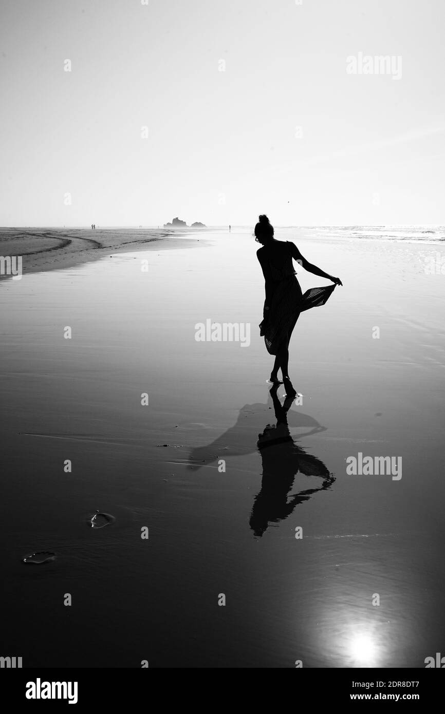 Woman in dress wading in water Black and White Stock Photos & Images