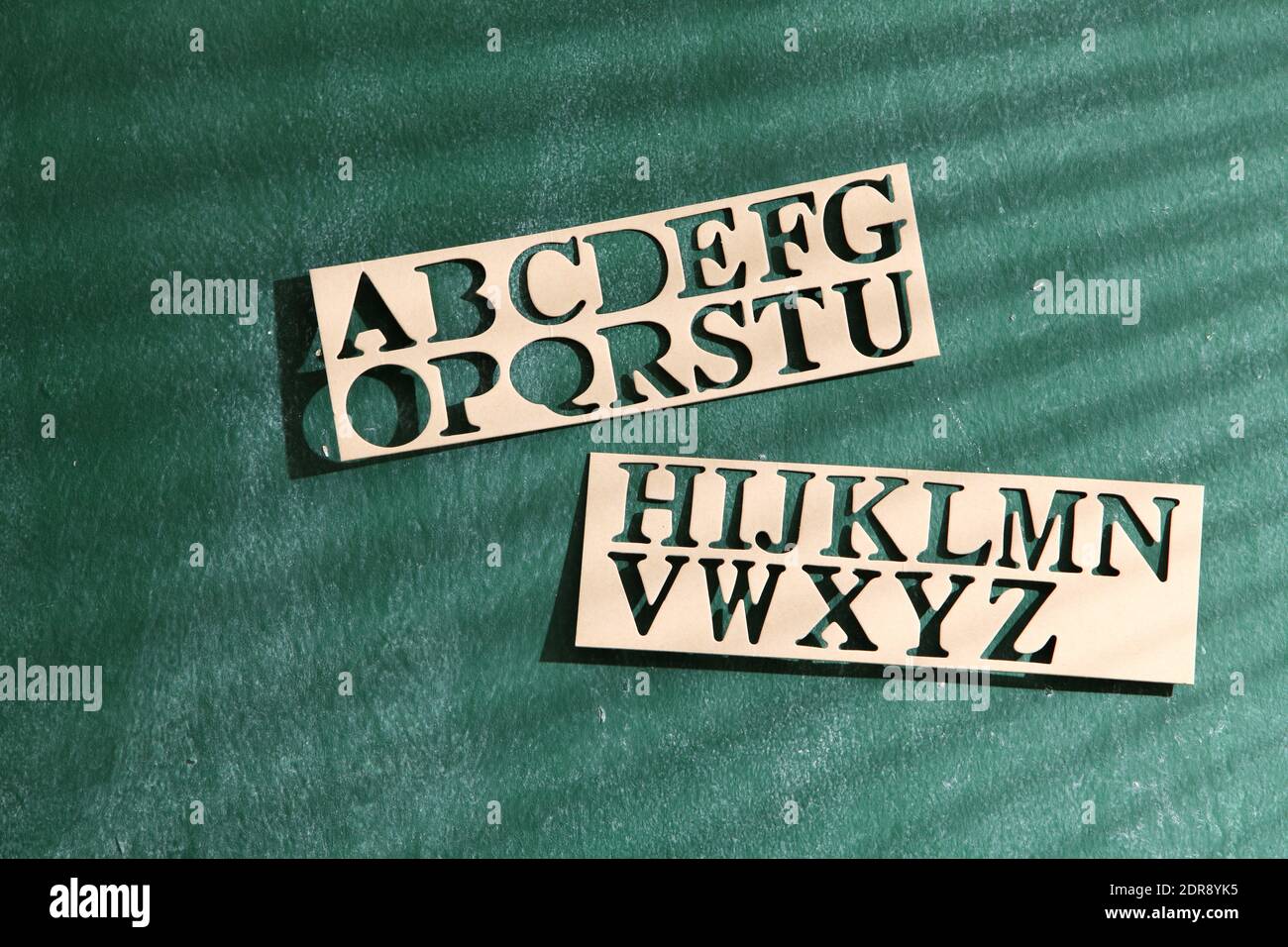 Stencils On Green Wall Stock Photo Alamy