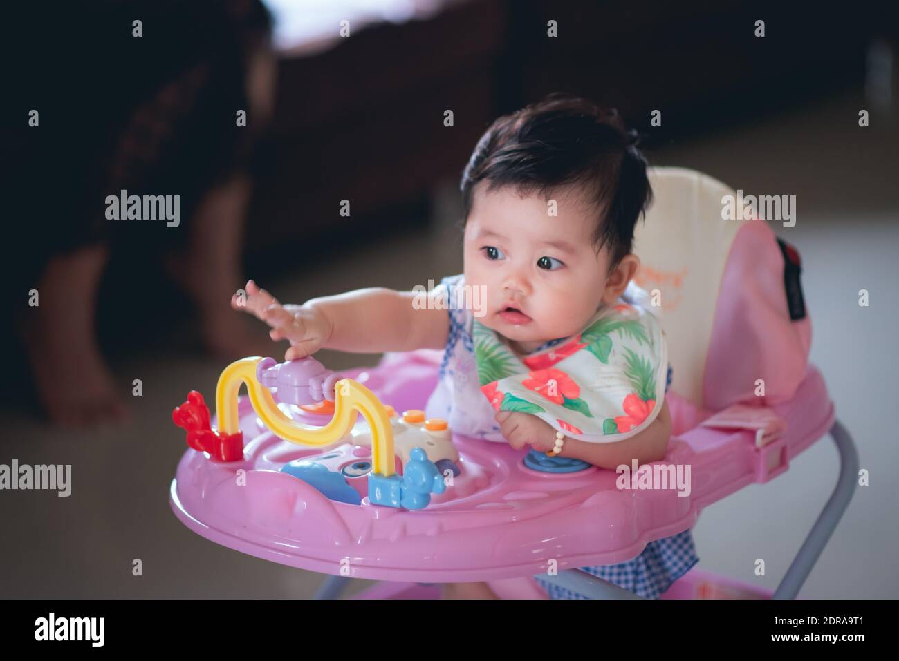 Cute Baby Girl In Walker At Home Stock Photo Alamy