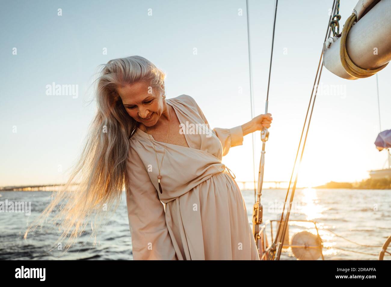 Beautiful Senior Woman In Boat Sailing On Sea Against Sky Stock Photo Alamy