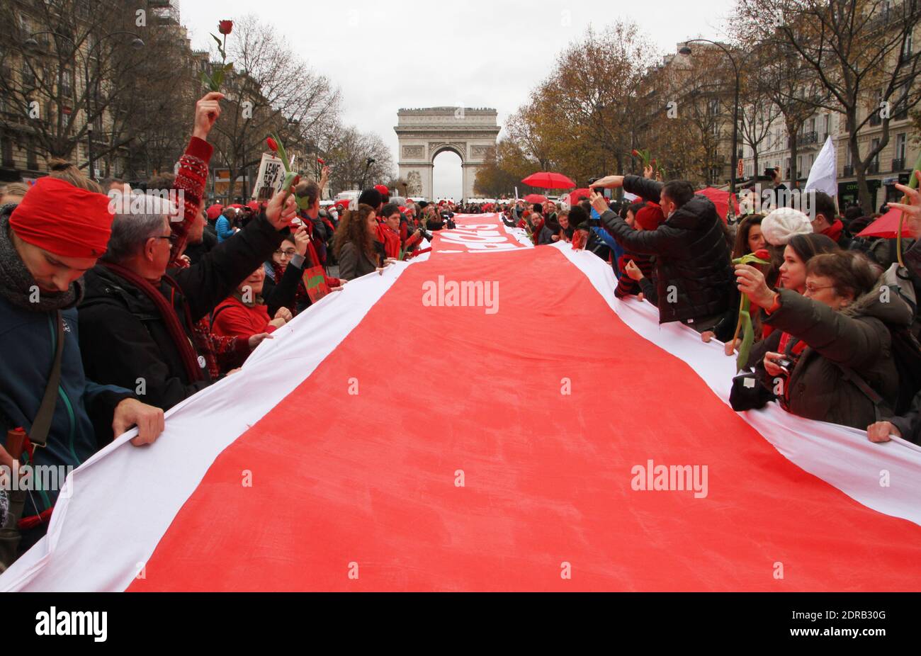 Activists form a giant red line during a demonstration near the Arc de Triomphe at the Avenue de la Grande armee boulevard in Paris, France, on December 12, 2015, as a proposed 195-nation accord to curb emissions of the heat-trapping gases that threaten to wreak havoc on Earth's climate system is to be presented at the United Nations conference on climate change COP21 in Le Bourget, on the outskirts of Paris. Photo by Somer/ABACAPRESS.COM Stock Photo