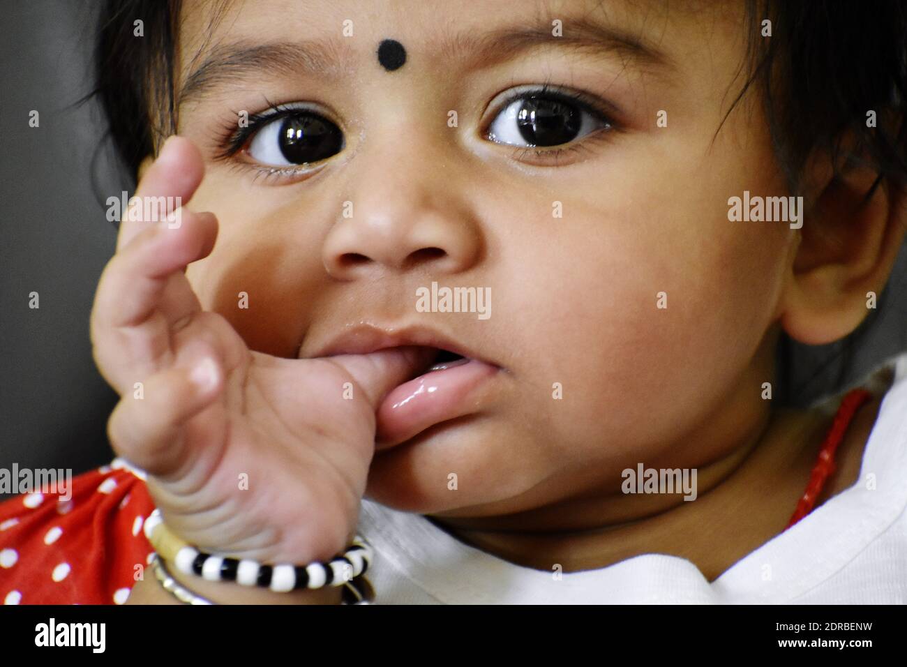 Close-up Of Cute Girl With Finger In Mouth Looking Away Stock Photo - Alamy Close-up Of Cute Girl With Finger In Mouth Looking Away Stock Photo - Alamy