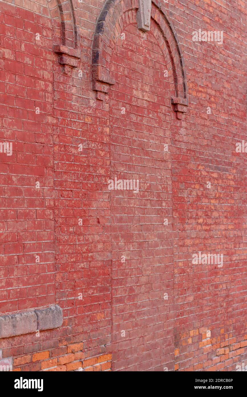 Full frame shabby chic view of an eroding antique exterior brick wall