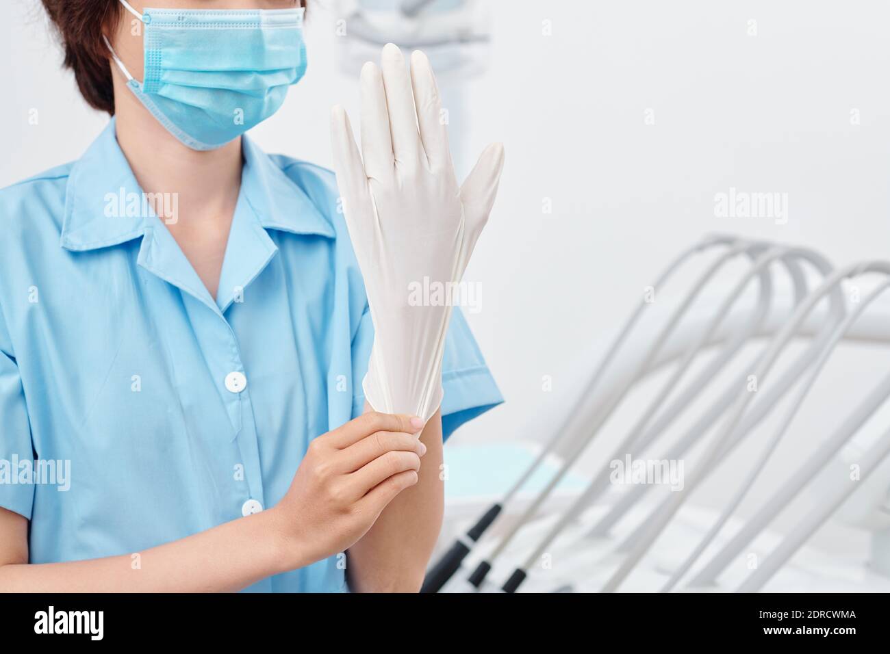 Nurse putting on rubber glove Stock Photo