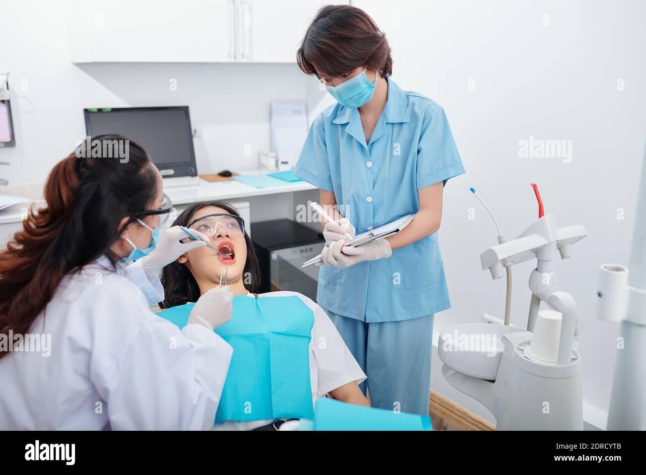 Dentist checking teeth of patient Stock Photo Alamy