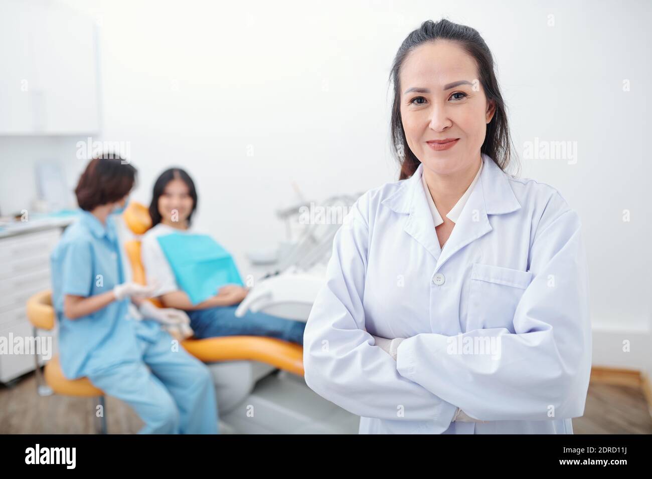Confident smiling female dentist Stock Photo