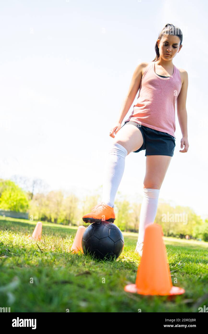 Young female soccer player practicing on field Stock Photo Alamy