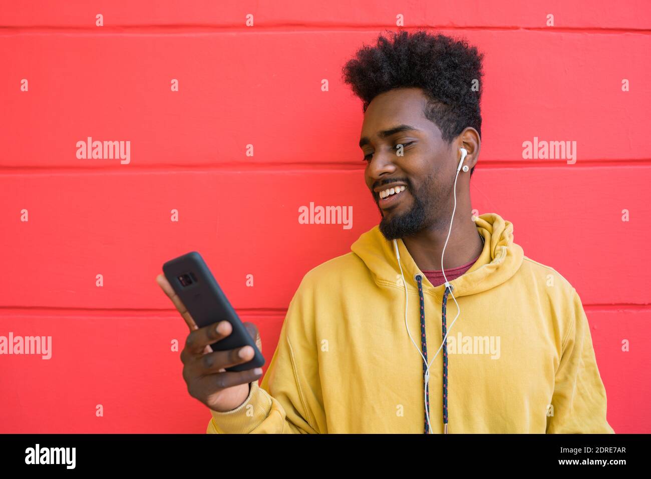 Afro man using his mobile phone. Stock Photo