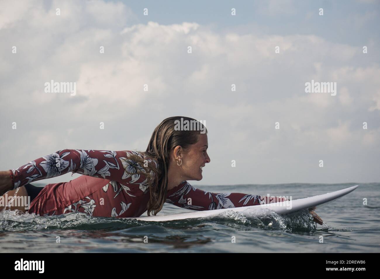 Woman lying on surfboard in hires stock photography and images Alamy