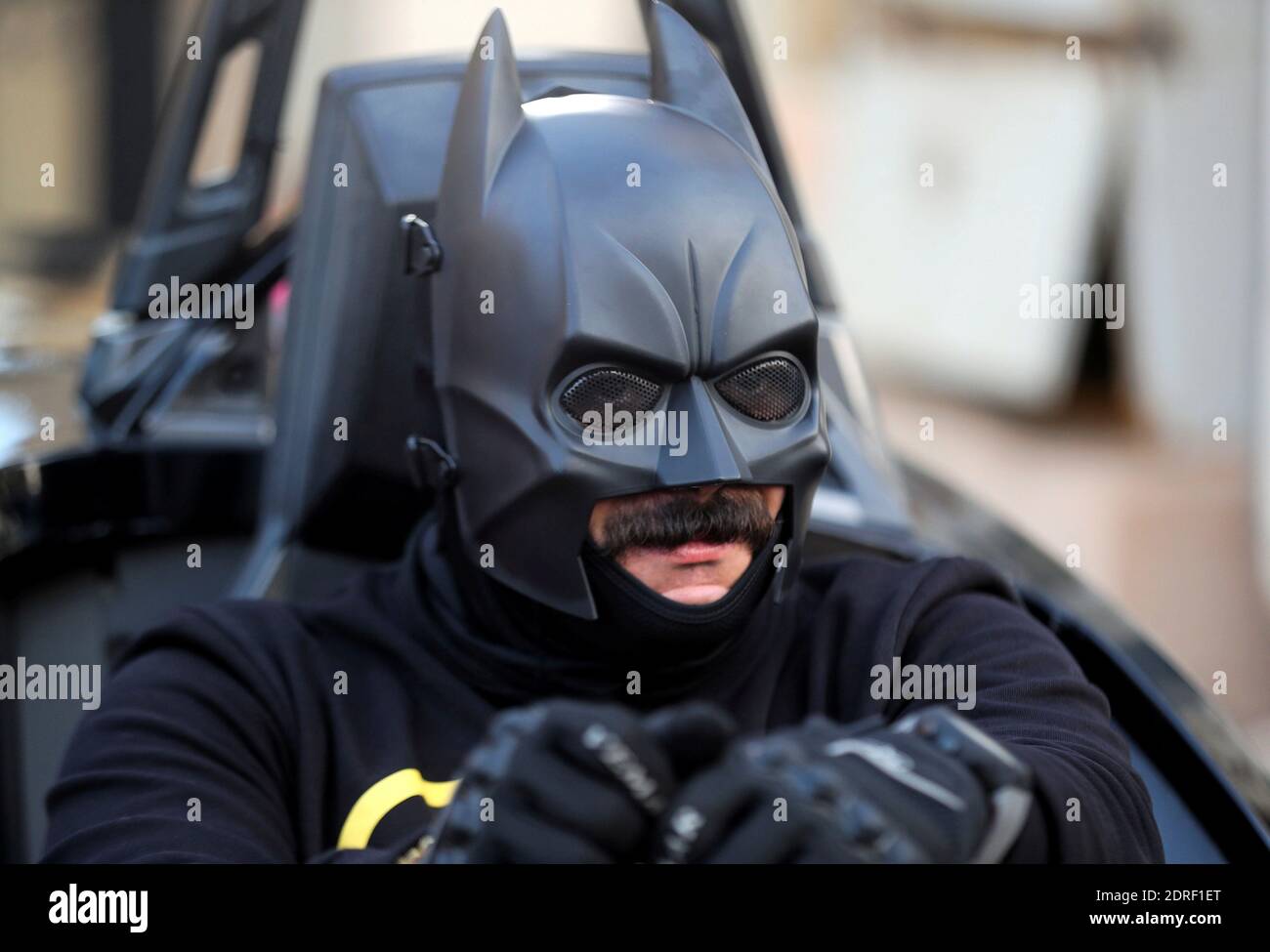 Bassem Raaof, 28, dressed in a Batman costume, drives his 