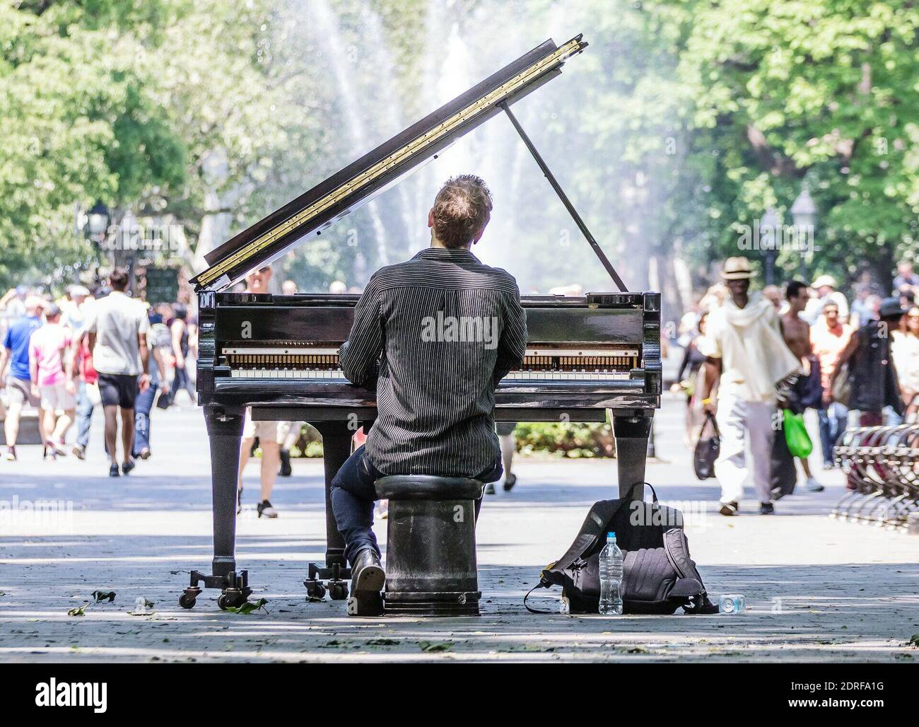 Man Playing Piano While Sitting On City Street Stock Photo - Alamy