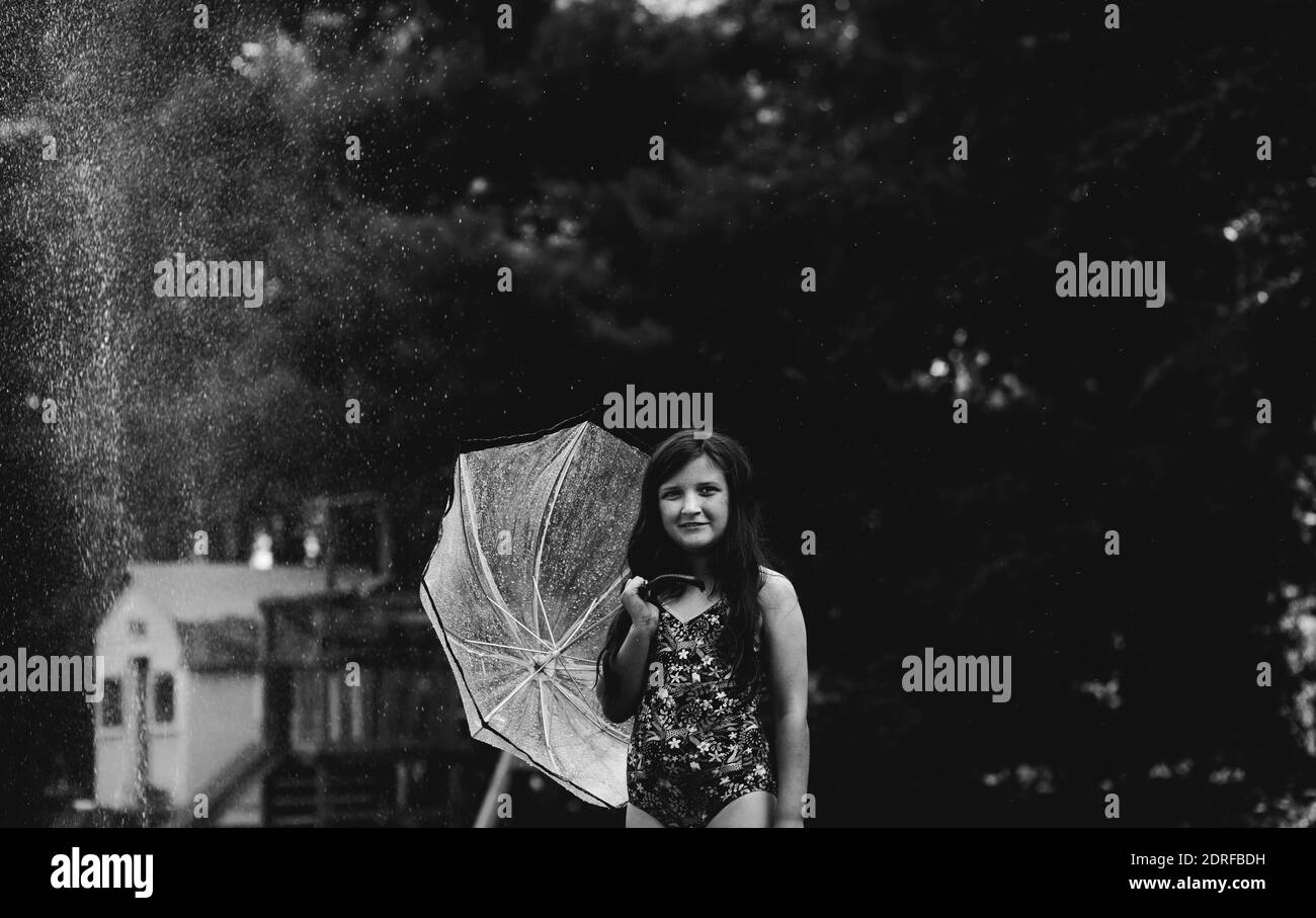 Girl holding umbrella Black and White Stock Photos & Images Alamy
