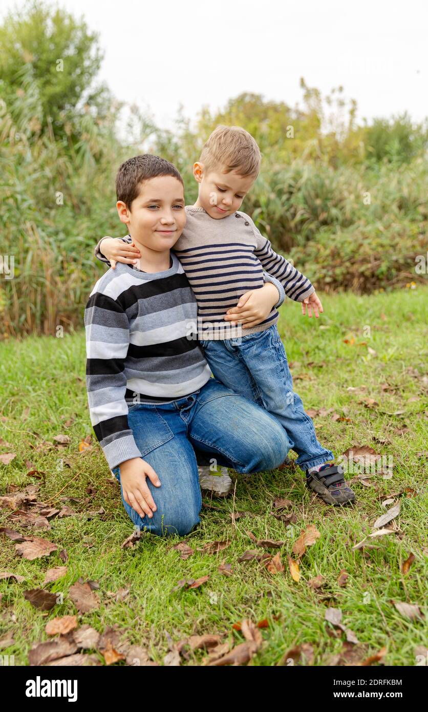 Older brother hugging his younger brother. Happy family. Brother ...